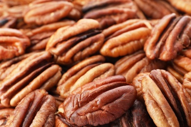 Photo of Shelled pecan nuts as background, closeup. Nutritive food