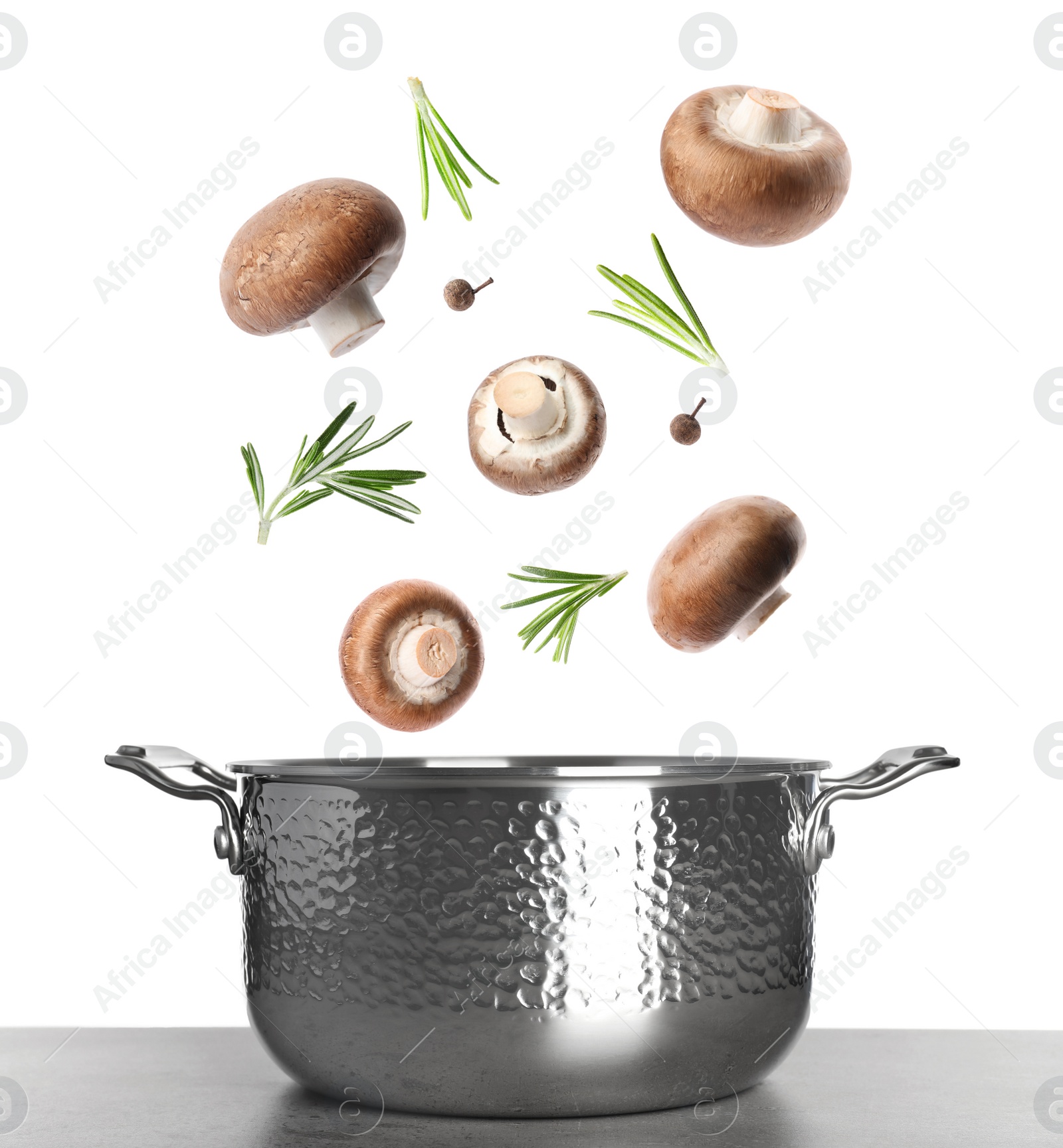 Image of Fresh mushrooms, rosemary and peppercorns falling into pot on white background