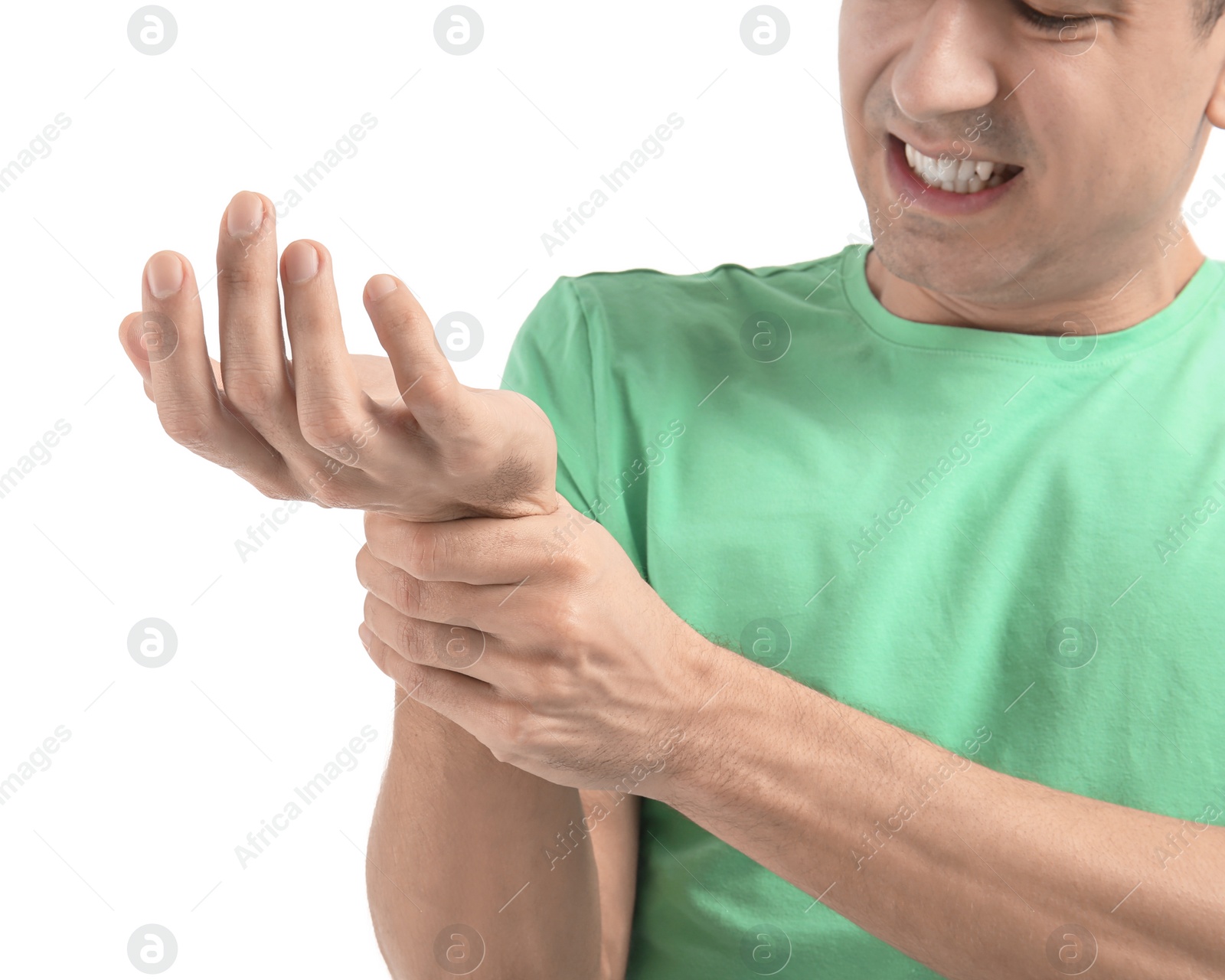 Photo of Young man suffering from pain in wrist on white background, closeup