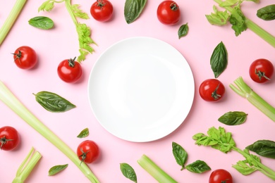 Photo of Flat lay composition with fresh salad ingredients on pink background, space for text