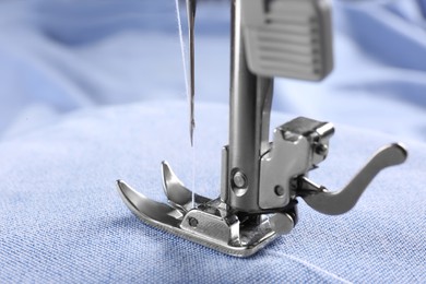 Photo of Closeup view of sewing machine with fabric