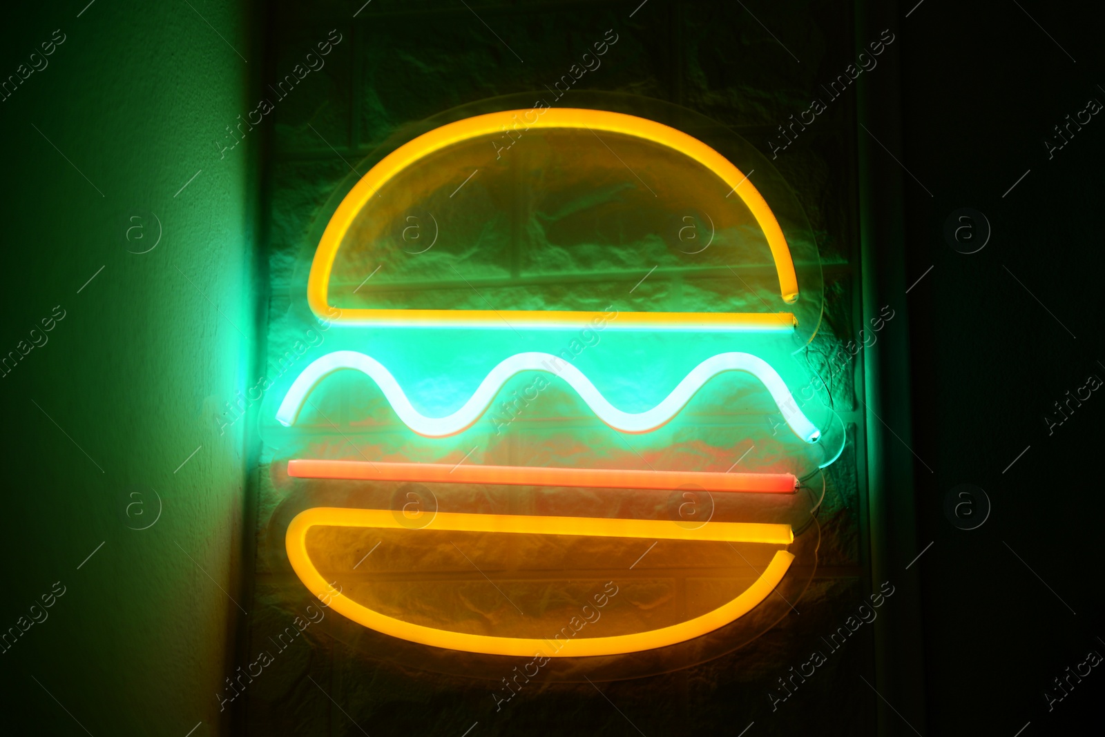 Photo of Burger shape neon sign on wall indoors