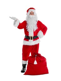 Photo of Man in Santa Claus costume with bag posing on white background