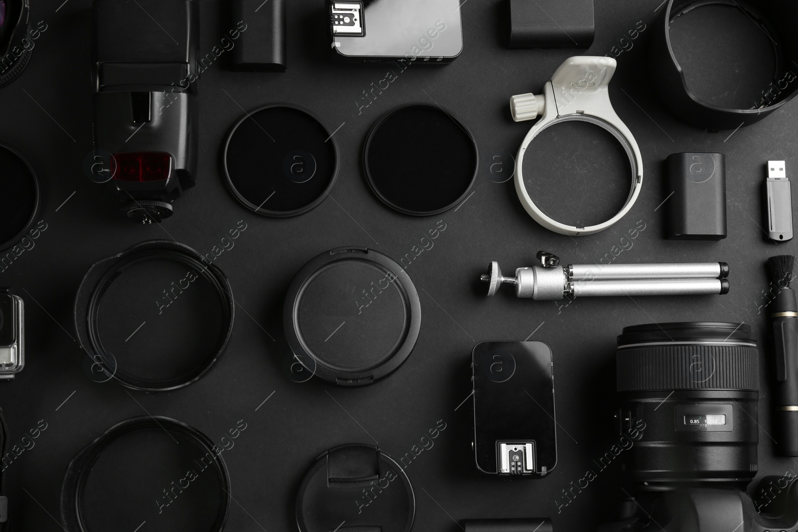 Photo of Flat lay composition with equipment for professional photographer on black background