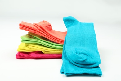 Photo of Different colorful socks on white background