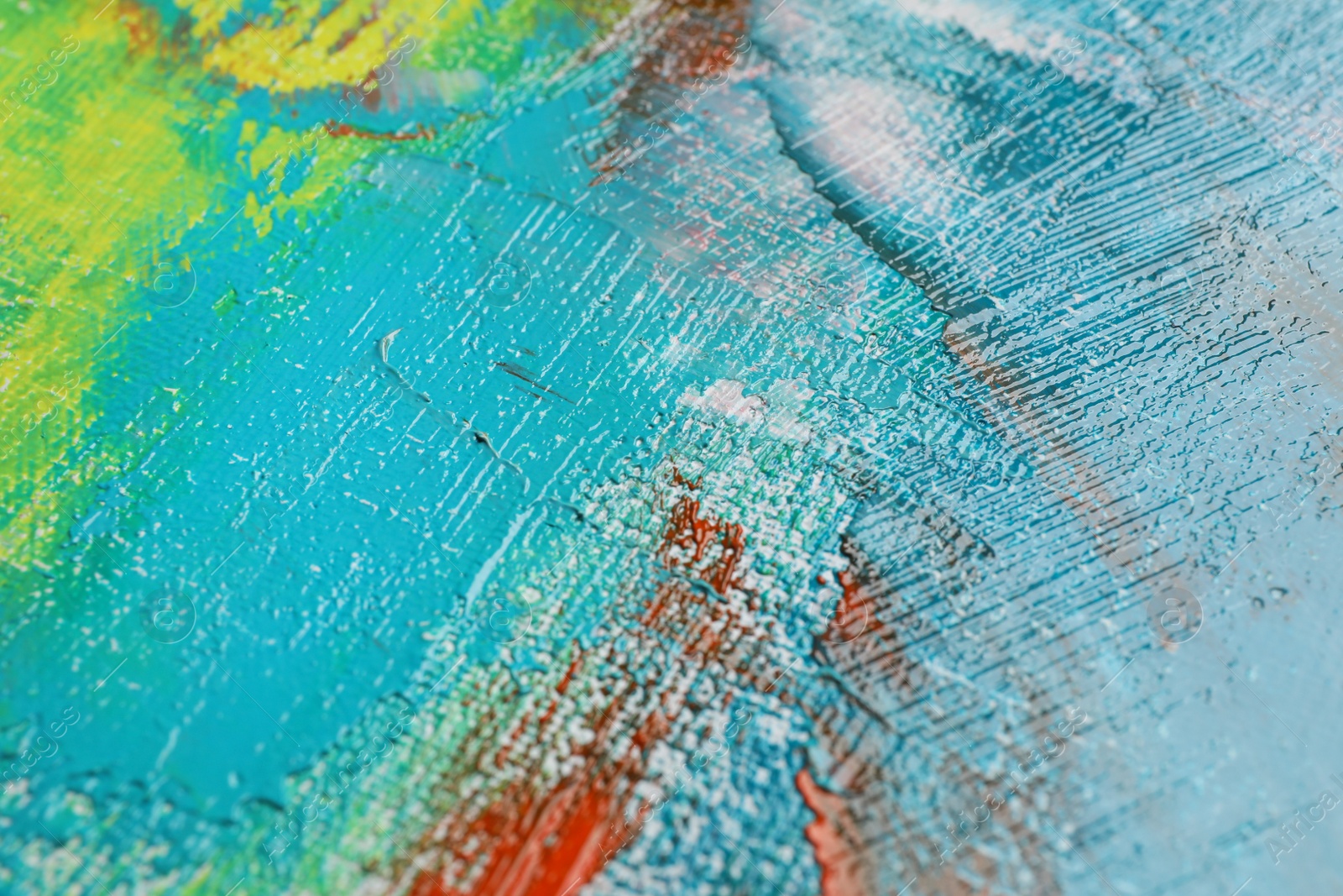 Photo of Strokes of colorful acrylic paints on canvas, closeup