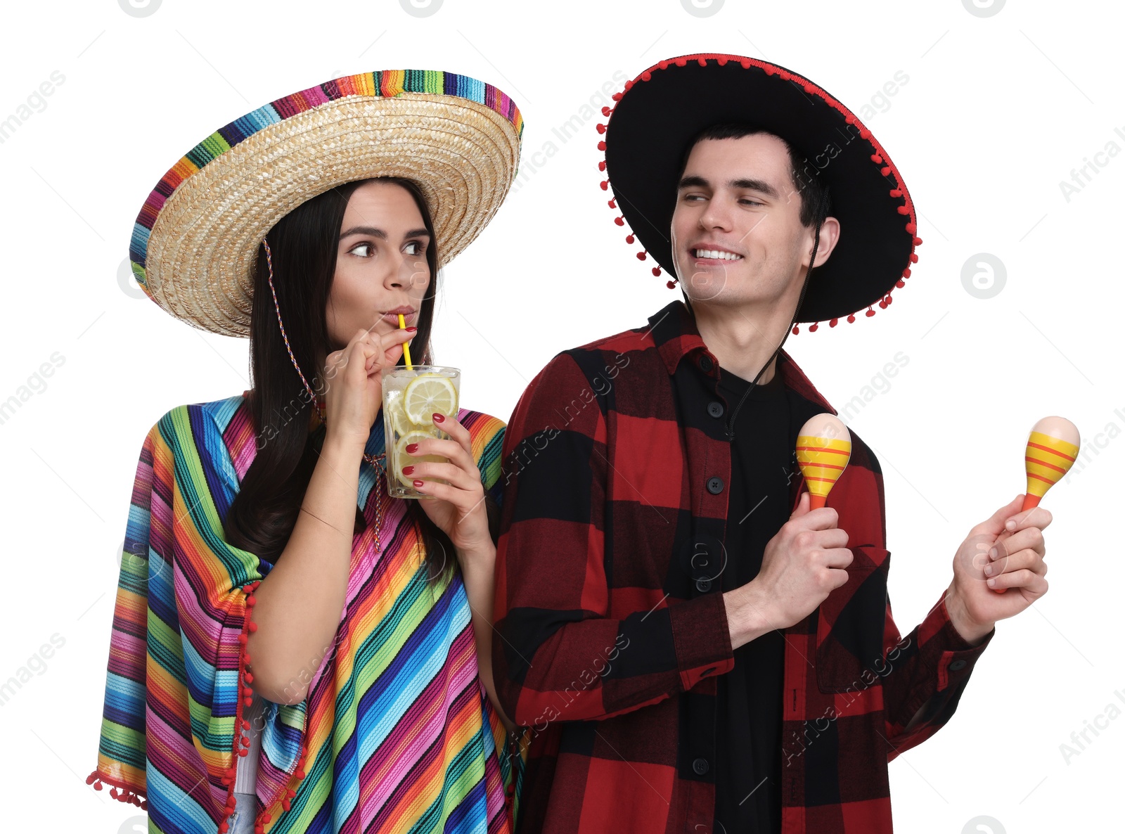 Photo of Lovely couple in Mexican sombrero hats with cocktail and maracas on white background