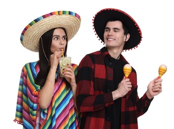 Photo of Lovely couple in Mexican sombrero hats with cocktail and maracas on white background