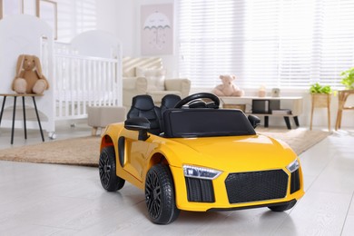 Yellow car in room at home. Child's toy