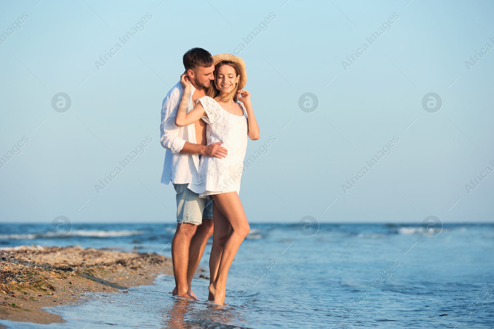 Photo of Young couple spending time together on beach