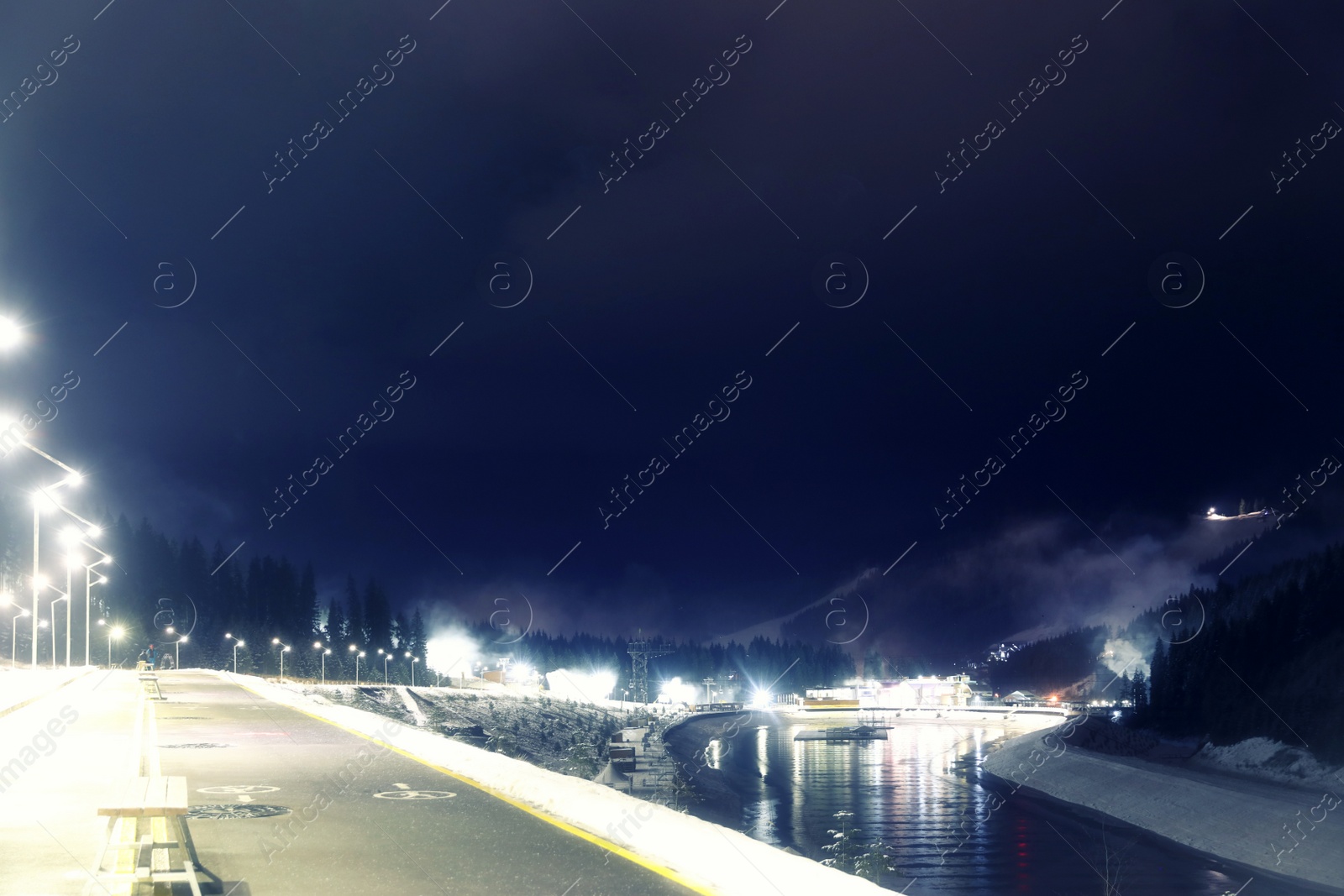 Photo of View of mountain resort near forest at night in winter