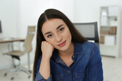 Photo of Portrait of beautiful young woman in office