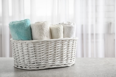 Basket with clean towels on table