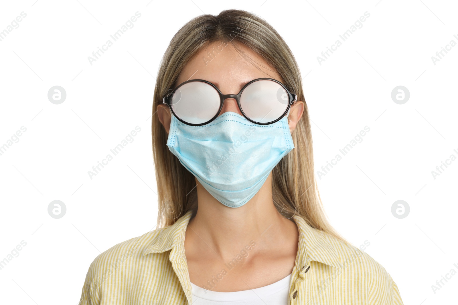 Photo of Woman with foggy glasses caused by wearing disposable mask on white background. Protective measure during coronavirus pandemic