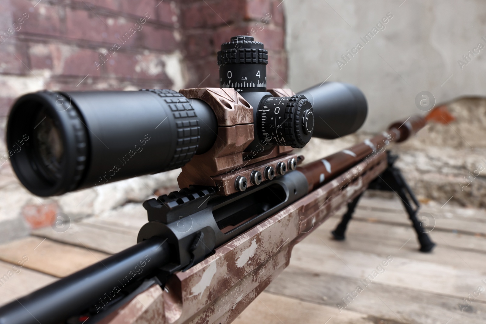 Photo of Closeup view of modern powerful sniper rifle with telescopic sight outdoors