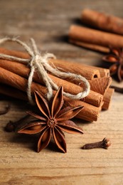 Different aromatic spices on wooden table, closeup