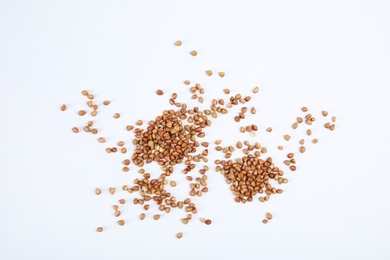 Photo of Uncooked buckwheat on white background, top view