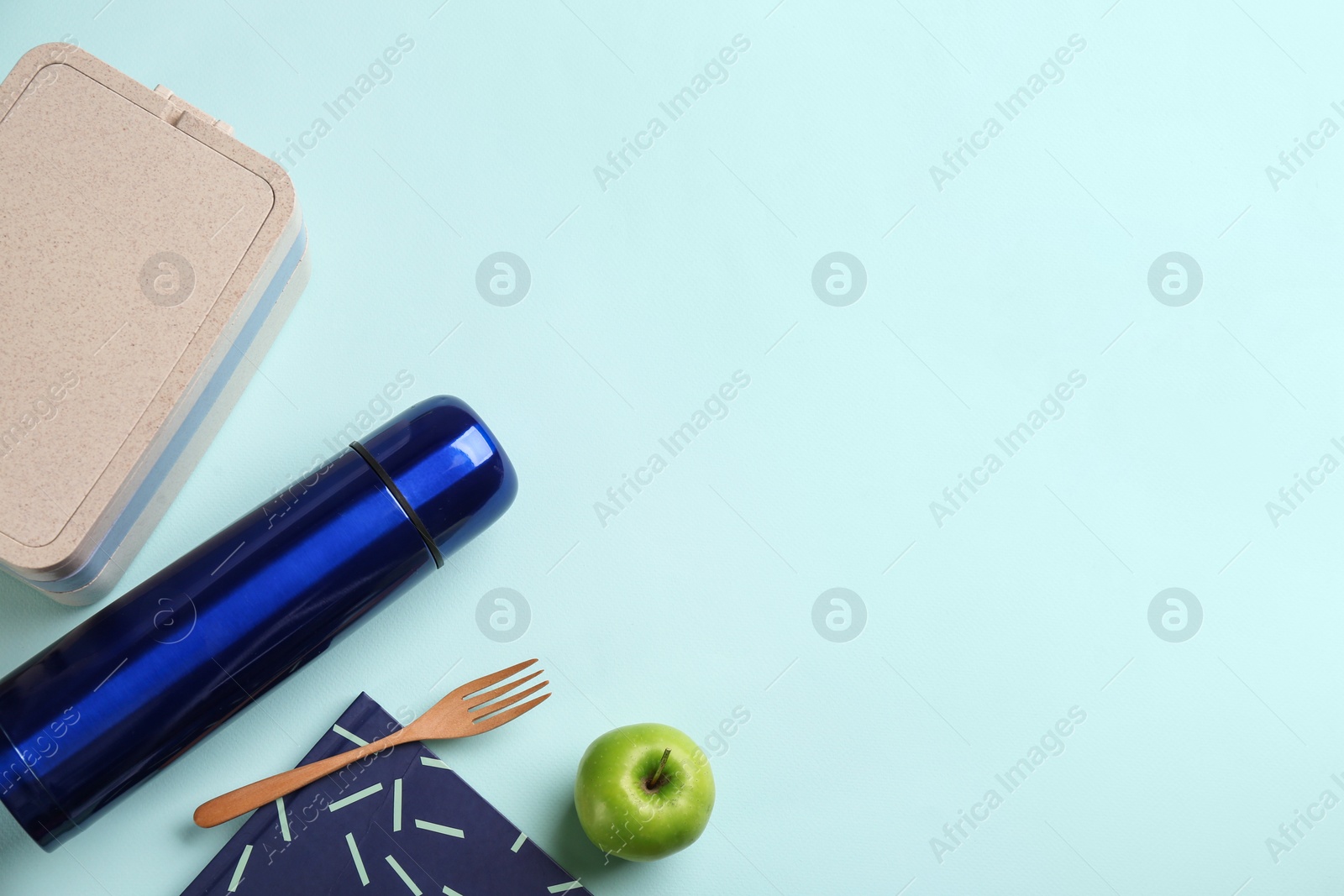 Photo of Flat lay composition with thermos on turquoise background. Space for text