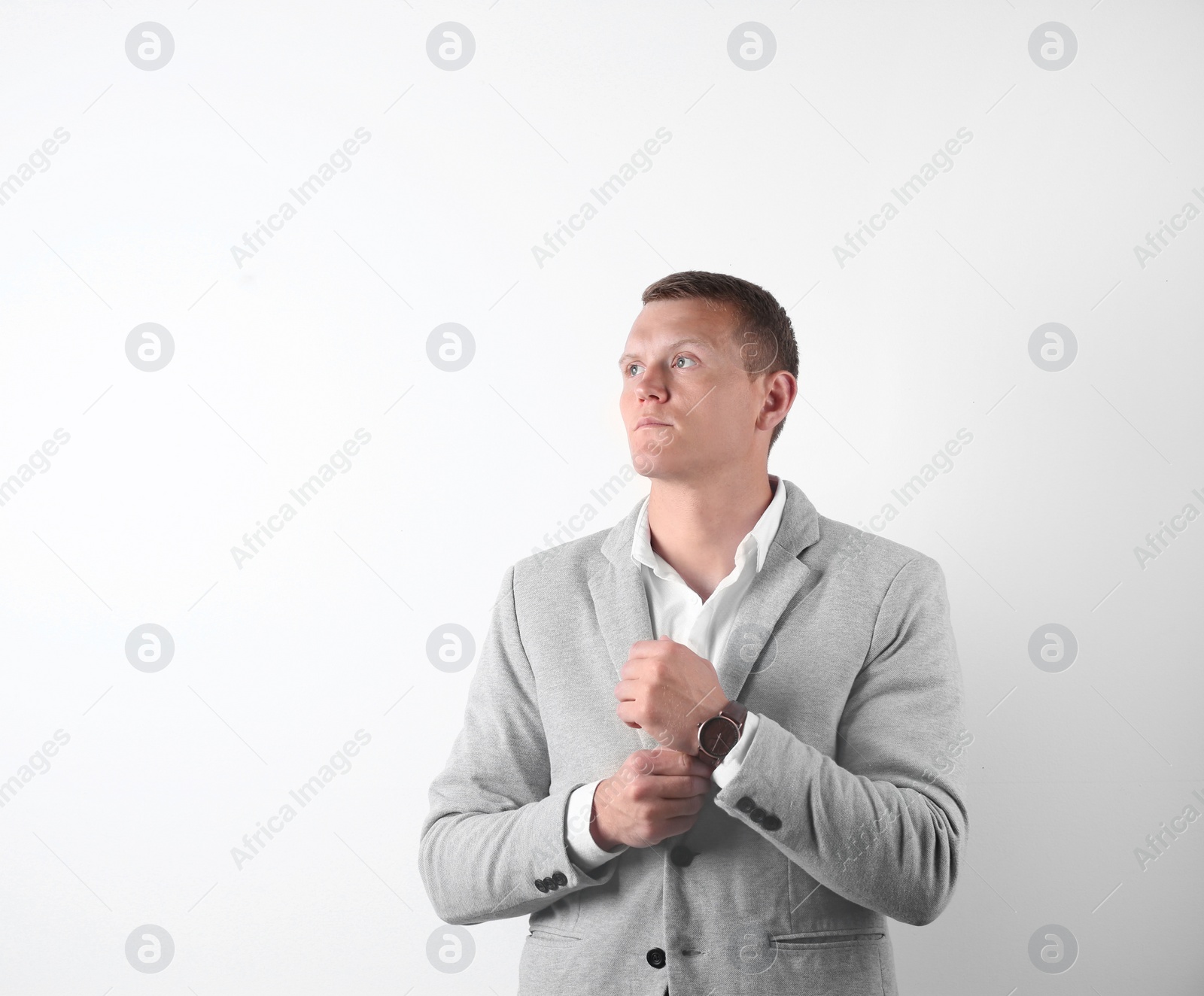 Photo of Handsome young man in suit on white background