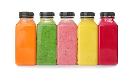 Photo of Bottles with delicious detox smoothies on white background