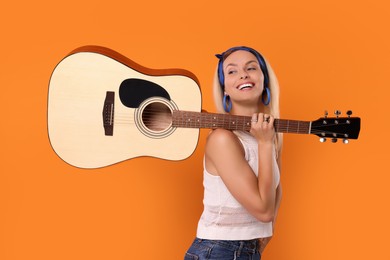 Photo of Happy hippie woman with guitar on orange background