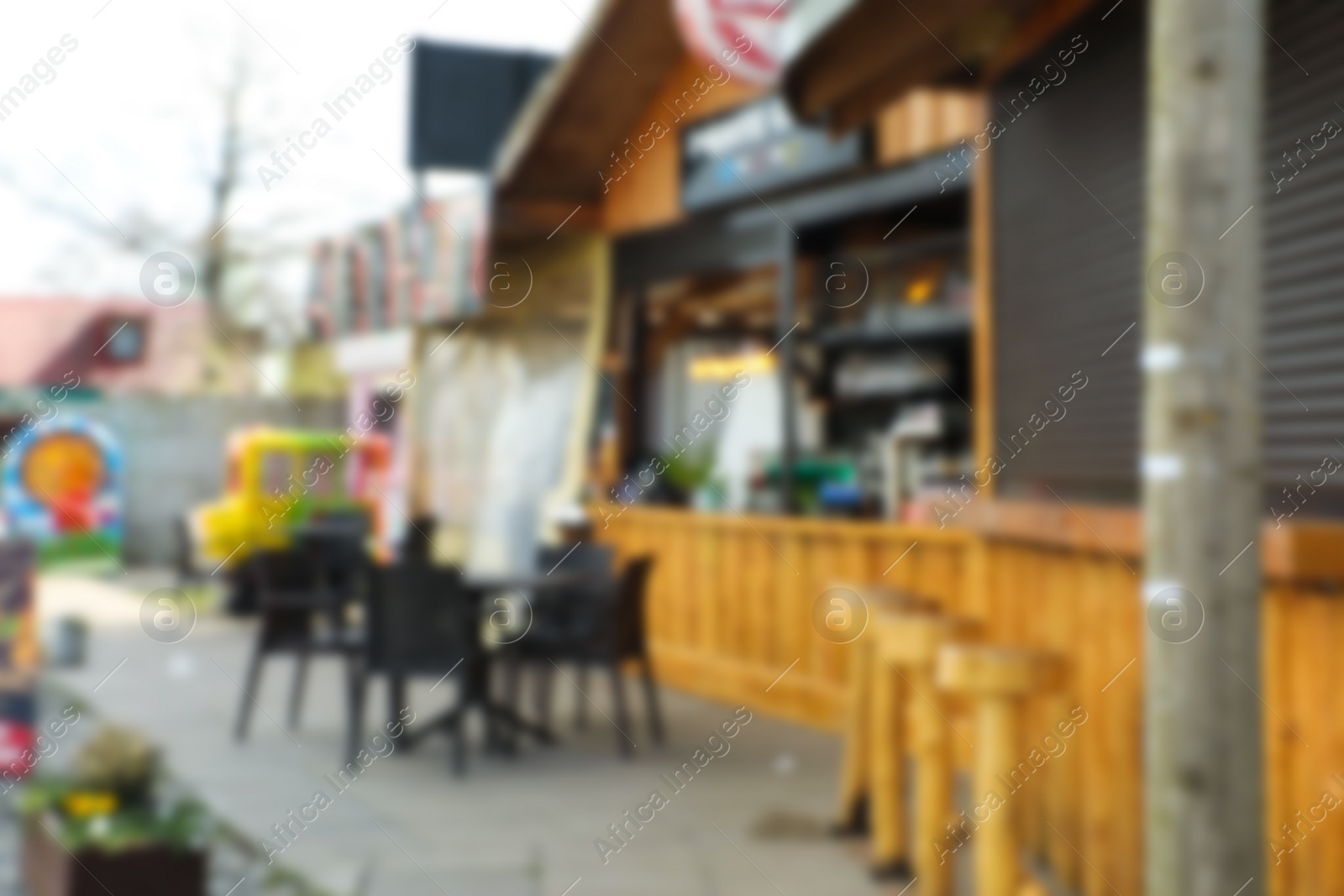 Photo of Blurred view of modern outdoor cafe on city street