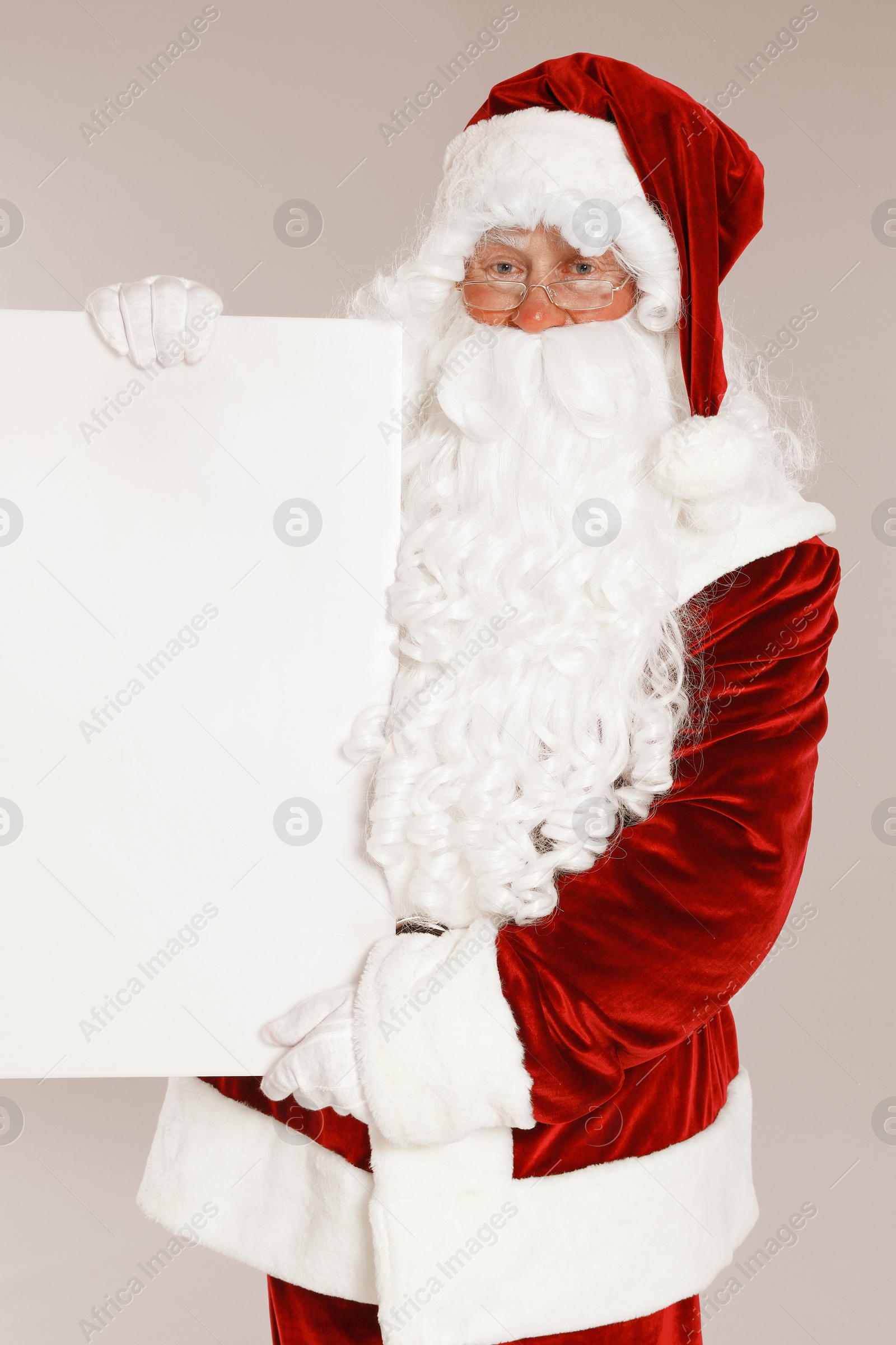 Photo of Authentic Santa Claus with blank banner on grey background. Space for design