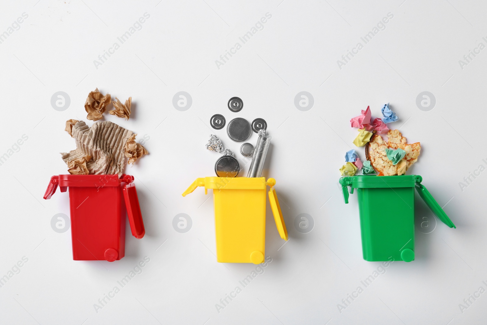 Photo of Trash bins and different garbage isolated on white, top view. Waste recycling concept