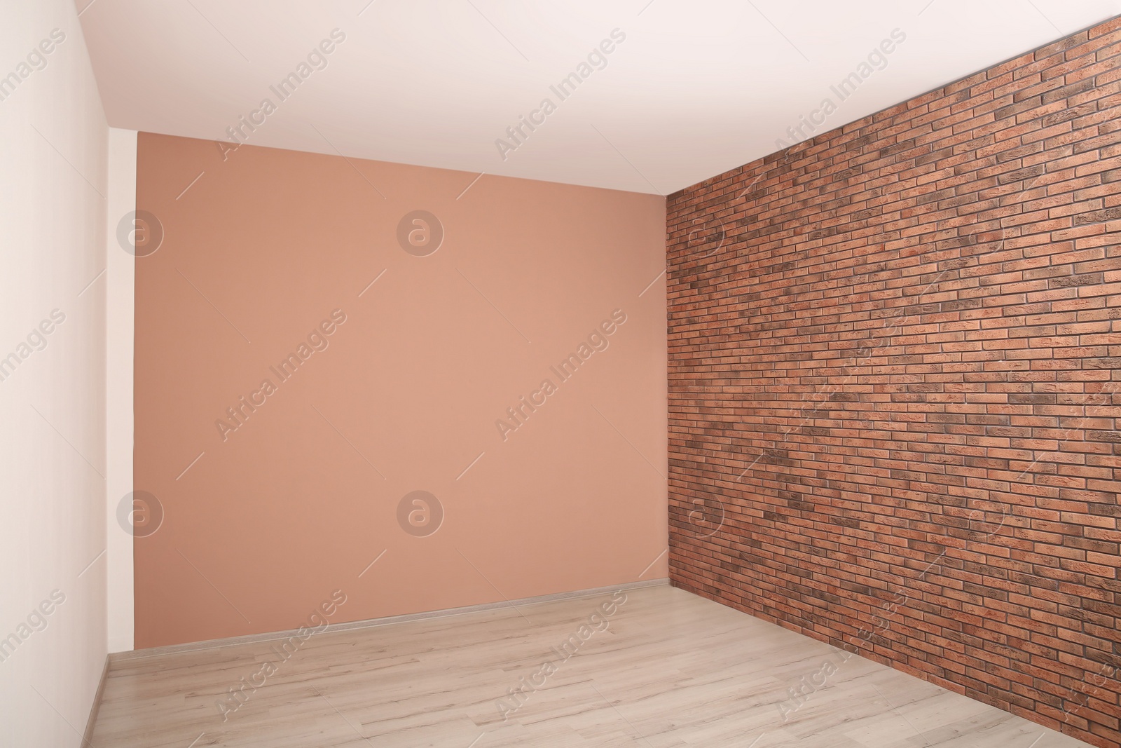 Photo of Empty room with different walls, white door and laminated floor