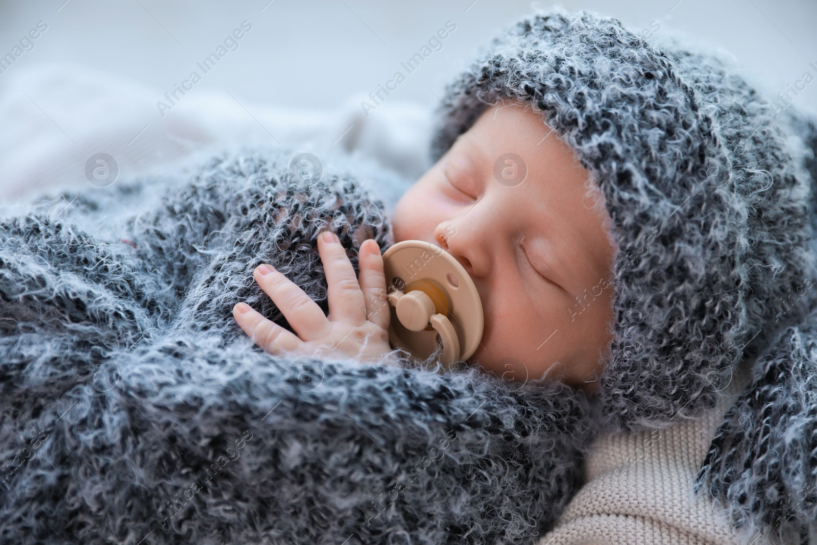 Photo of Cute newborn baby sleeping on plaid, closeup