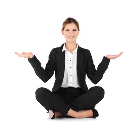Photo of Businesswoman sitting in lotus position and showing balance gesture on white background