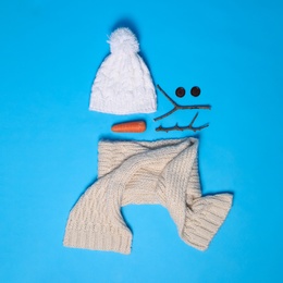 Photo of Set of materials for snowman on light blue background, flat lay