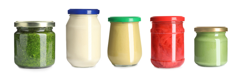 Image of Set with delicious sauces in glass jars on white background. Banner design