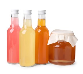 Delicious kombucha in glass bottles and jar isolated on white