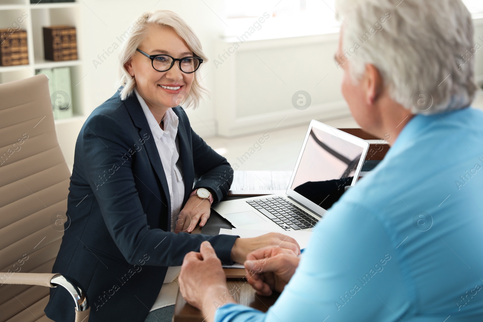 Photo of Female notary working with client in office