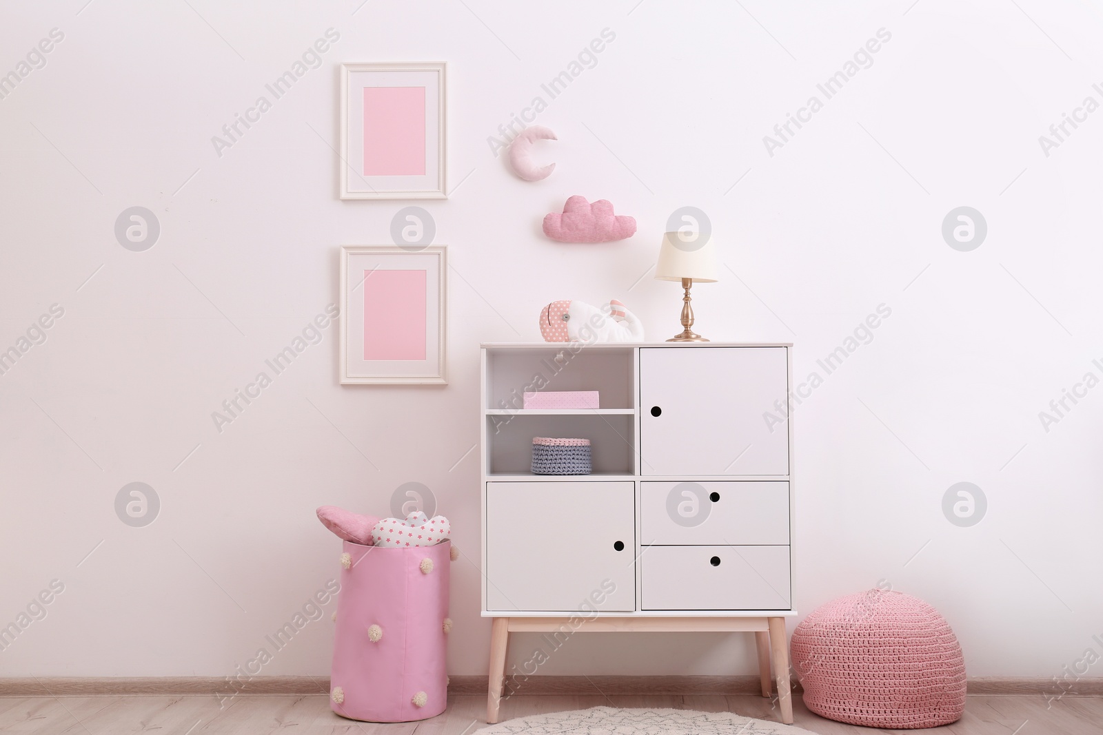 Photo of Nursery room interior with cabinet and toys