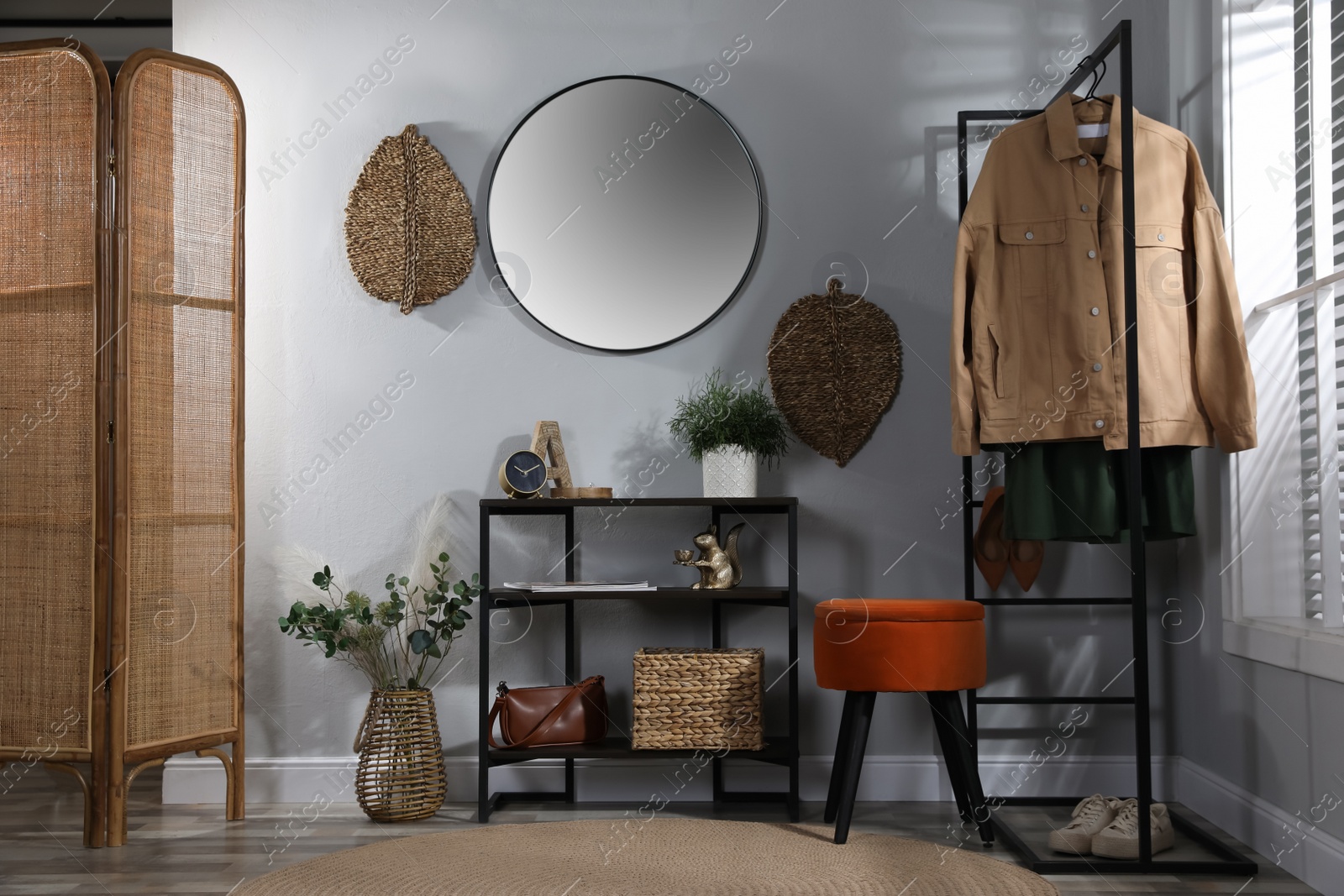 Photo of Stylish room interior with console table and beautiful decor elements