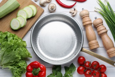 Photo of Flat lay composition with frying pan and fresh products on white wooden table