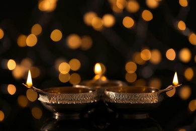Diwali diyas or clay lamp against blurred lights