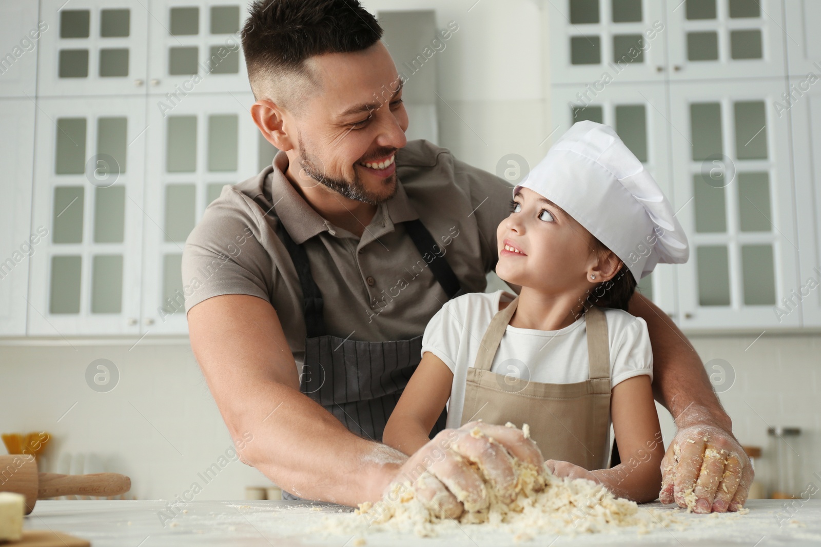Photo of Father and daughter cooking together in kitchen