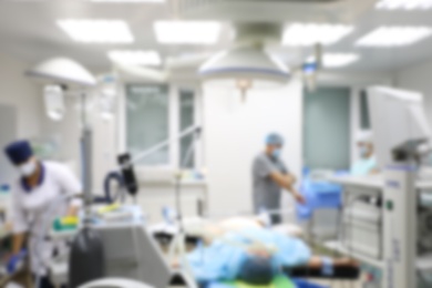 Photo of Blurred view of doctor and nurses preparing for surgery in operating room