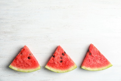 Photo of Flat lay composition with watermelon slices on white wooden background