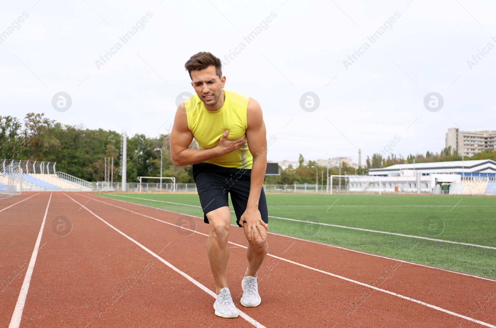 Photo of Young man having heart attack while running at stadium