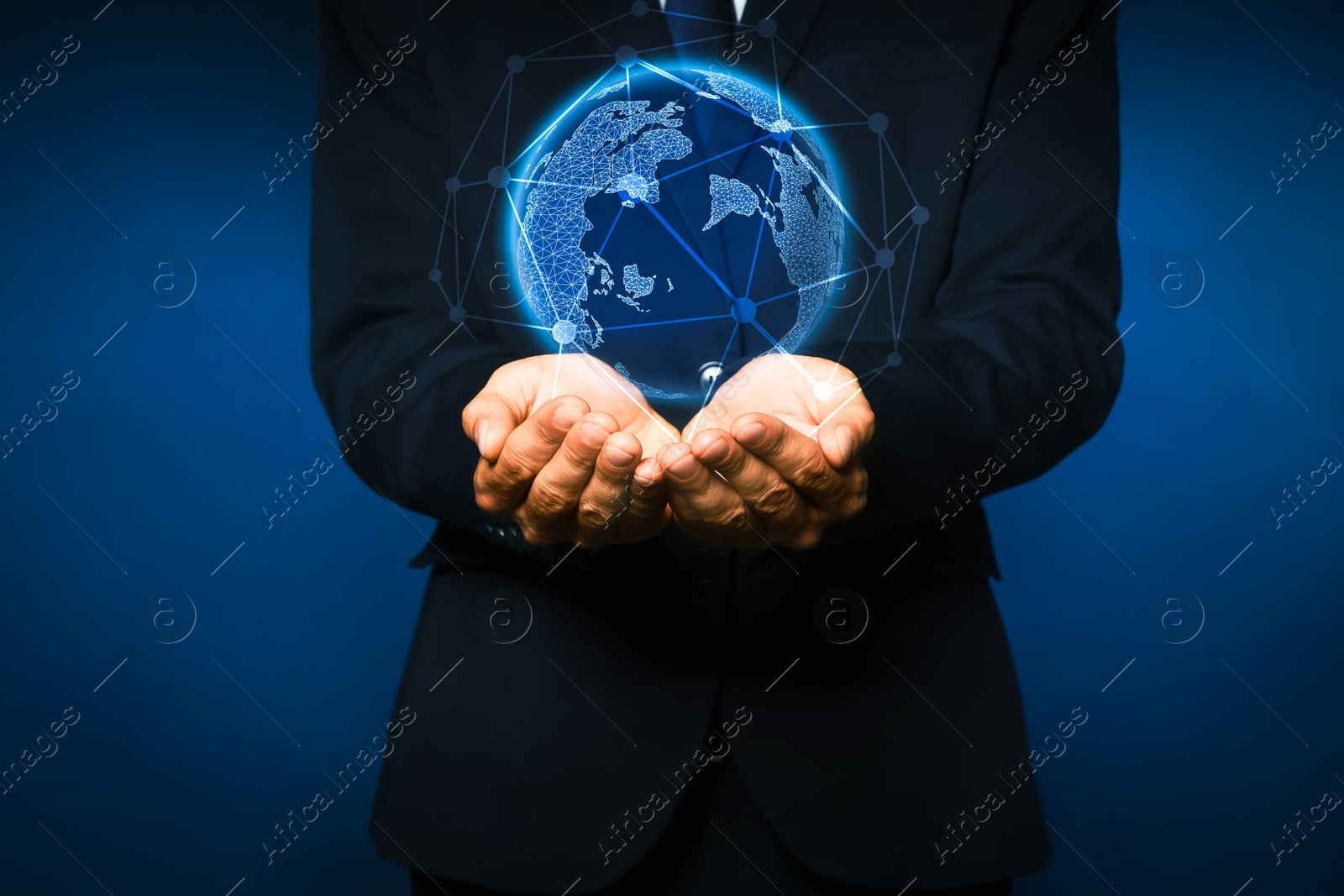 Image of Global innovation. Businessman holding virtual planet on dark blue background, closeup