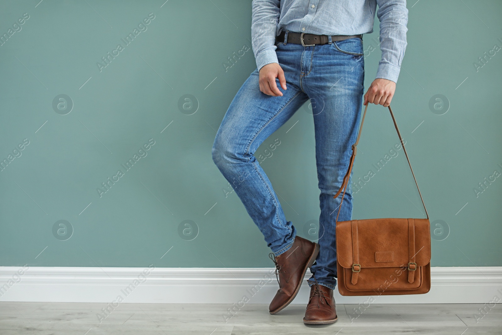 Photo of Man in leather shoes with stylish bag indoors