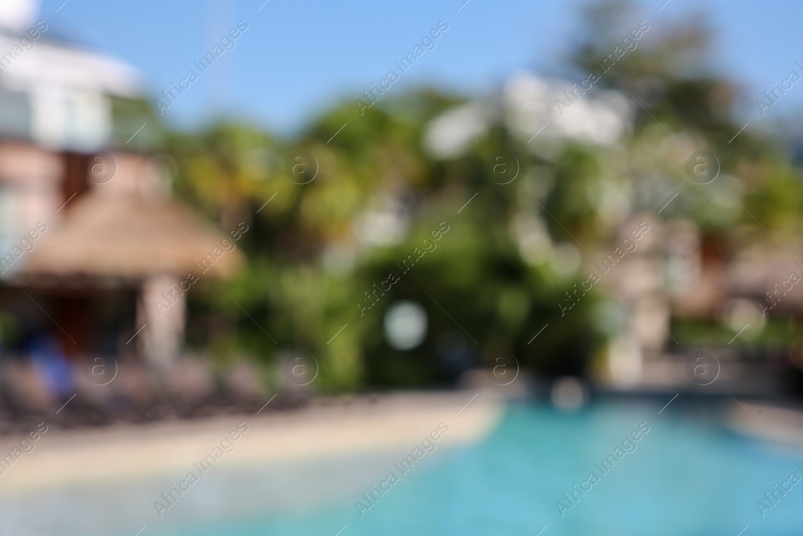 Photo of Blurred view of outdoor swimming pool at resort on sunny day