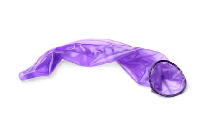 Photo of Purple used condom on white background. Safe sex concept