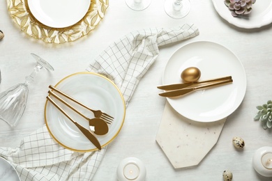 Photo of Festive Easter table setting on wooden background, top view