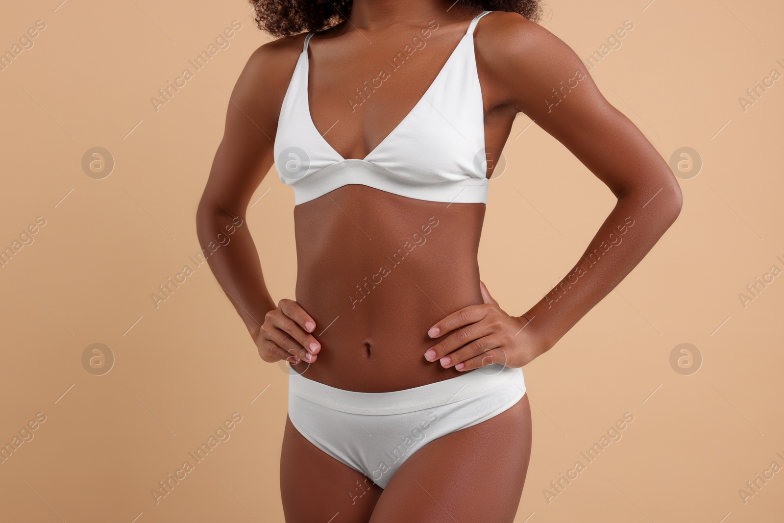 Photo of Woman in stylish bikini on beige background, closeup