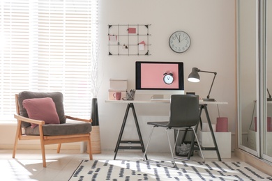 Photo of Modern computer on desk in room. Home workplace